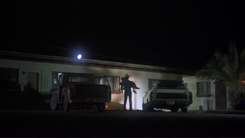 Movie still from “Alice Doesn't Live Here Anymore” (1974), directed by Martin Scorsese – A man standing in front of a truck at night; Wide shot, Low angle