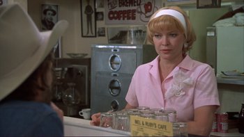 Movie still from “Alice Doesn't Live Here Anymore” (1974), directed by Martin Scorsese – A woman sitting at a counter in a cafe; Medium shot, Over the shoulder angle