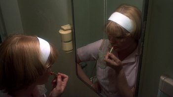 Movie still from “Alice Doesn't Live Here Anymore” (1974), directed by Martin Scorsese – A woman is putting lipstick on in a mirror; Close Up shot, Over the shoulder angle