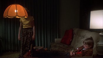 Movie still from “Alice Doesn't Live Here Anymore” (1974), directed by Martin Scorsese – A man and a woman in a living room; Wide shot, High angle
