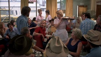 Movie still from “Alice Doesn't Live Here Anymore” (1974), directed by Martin Scorsese – A group of people sitting around a table; Wide shot, Over the shoulder angle