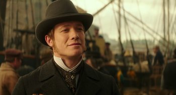 Movie still from “Alice Through the Looking Glass” (2016), directed by James Bobin – A man wearing a hat and a suit; Close Up shot, Over the shoulder angle