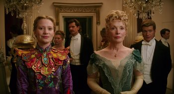 Movie still from “Alice Through the Looking Glass” (2016), directed by James Bobin – Two people standing next to each other in formal wear; Medium shot, Low angle