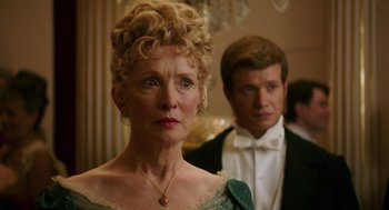 Movie still from “Alice Through the Looking Glass” (2016), directed by James Bobin – An older woman and a young man in formal wear; Close Up shot, Over the shoulder angle