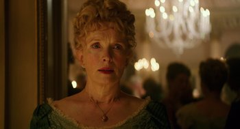 Movie still from “Alice Through the Looking Glass” (2016), directed by James Bobin – An older woman with blonde curly hair wearing a green dress; Close Up shot, Low angle