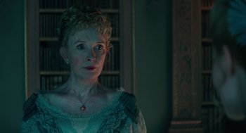 Movie still from “Alice Through the Looking Glass” (2016), directed by James Bobin – An older woman with blonde curly hair wearing a blue dress; Close Up shot, Low angle