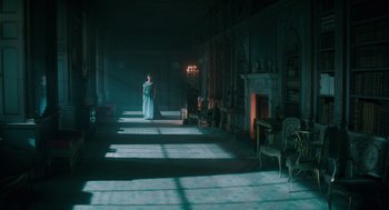 Movie still from “Alice Through the Looking Glass” (2016), directed by James Bobin – A woman in a white dress standing in a dark room; Extreme Wide shot, High angle