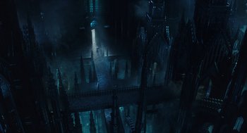 Movie still from “Alice Through the Looking Glass” (2016), directed by James Bobin – An aerial view of a dark city with a bridge; Extreme Wide shot, High angle