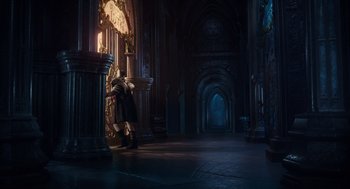 Movie still from “Alice Through the Looking Glass” (2016), directed by James Bobin – A man standing in front of a clock in a dark room; Wide shot, Low angle
