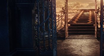 Movie still from “Alice Through the Looking Glass” (2016), directed by James Bobin – A woman looking out of an iron gate at the sky; Extreme Wide shot, High angle