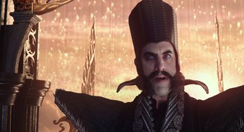 Movie still from “Alice Through the Looking Glass” (2016), directed by James Bobin – A man with a beard wearing a hat and holding a whip; Close Up shot, Low angle