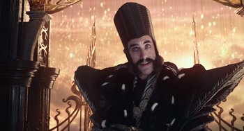 Movie still from “Alice Through the Looking Glass” (2016), directed by James Bobin – A man with a beard wearing a black hat; Close Up shot, Low angle