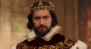 Movie still from “Alice Through the Looking Glass” (2016), directed by James Bobin – A person with a beard wearing a crown; Close Up shot, Low angle