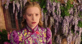 Movie still from “Alice Through the Looking Glass” (2016), directed by James Bobin – A woman in a purple floral dress standing in front of a tree; Close Up shot, Over the shoulder angle