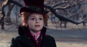 Movie still from “Alice Through the Looking Glass” (2016), directed by James Bobin – A child dressed as willy wonka in the snow; Close Up shot, Low angle
