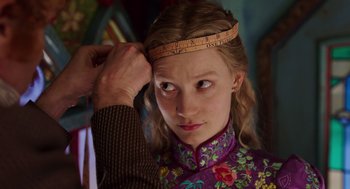 Movie still from “Alice Through the Looking Glass” (2016), directed by James Bobin – A young girl wearing a headband with a ruler on top of her head; Close Up shot, Over the shoulder angle