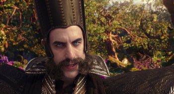 Movie still from “Alice Through the Looking Glass” (2016), directed by James Bobin – A person with a beard wearing a hat; Close Up shot, Over the shoulder angle