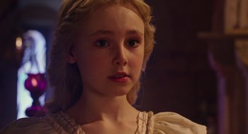 Movie still from “Alice Through the Looking Glass” (2016), directed by James Bobin – A young girl with blonde hair wearing a white dress; Close Up shot, Over the shoulder angle
