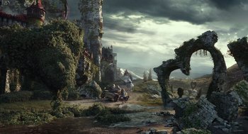 Movie still from “Alice Through the Looking Glass” (2016), directed by James Bobin – A group of people standing on top of a dirt road; Extreme Wide shot, Low angle