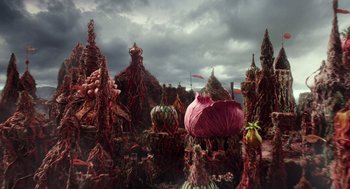 Movie still from “Alice Through the Looking Glass” (2016), directed by James Bobin – A bunch of vegetables that are in a field; Extreme Wide shot, High angle