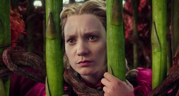 Movie still from “Alice Through the Looking Glass” (2016), directed by James Bobin – A woman holding two asparagus spears in front of her face; Close Up shot, Low angle