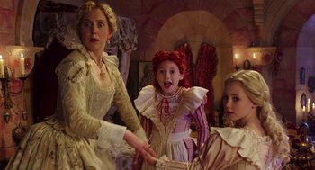 Movie still from “Alice Through the Looking Glass” (2016), directed by James Bobin – A woman and two young girls dressed in period costumes; Medium shot, High angle