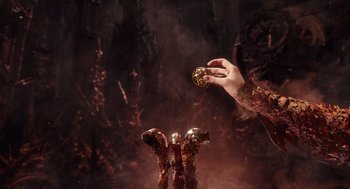 Movie still from “Alice Through the Looking Glass” (2016), directed by James Bobin – A hand holding a ball in front of a statue; Close Up shot, High angle