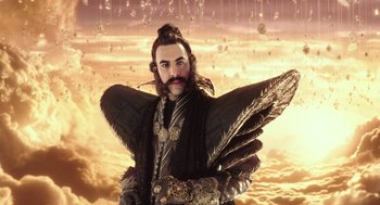 Movie still from “Alice Through the Looking Glass” (2016), directed by James Bobin – A man with a long beard and a long mustache; Medium shot, Low angle