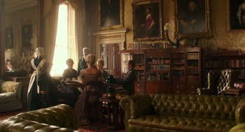 Movie still from “Alice Through the Looking Glass” (2016), directed by James Bobin – A group of people sitting in a room with furniture; Wide shot, Low angle