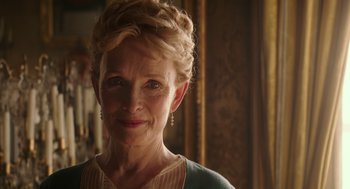 Movie still from “Alice Through the Looking Glass” (2016), directed by James Bobin – An older woman with blonde curly hair and wearing a blue dress; Close Up shot, Low angle