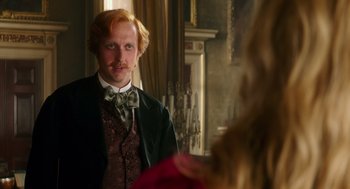 Movie still from “Alice Through the Looking Glass” (2016), directed by James Bobin – A man with a red beard and a mustache in front of a mirror; Close Up shot, Over the shoulder angle