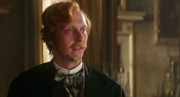 Movie still from “Alice Through the Looking Glass” (2016), directed by James Bobin – A person wearing a suit and tie; Close Up shot, Low angle