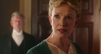 Movie still from “Alice Through the Looking Glass” (2016), directed by James Bobin – An older woman with blonde hair wearing a green dress; Close Up shot, Over the shoulder angle
