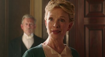 Movie still from “Alice Through the Looking Glass” (2016), directed by James Bobin – An older woman wearing a green dress and a man in a suit; Close Up shot, Over the shoulder angle