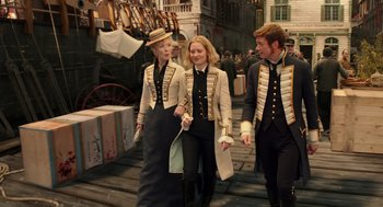 Movie still from “Alice Through the Looking Glass” (2016), directed by James Bobin – A group of people walking down a street; Medium shot, High angle