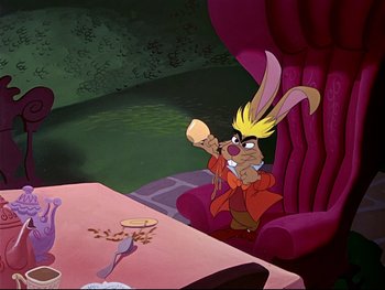 Movie still from “Alice in Wonderland” (1951), directed by Wilfred Jackson – A cartoon character sitting in front of a table with food on it; Medium shot, High angle