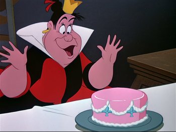 Movie still from “Alice in Wonderland” (1951), directed by Wilfred Jackson – A cartoon character sitting in front of a cake; Medium shot, Over the shoulder angle