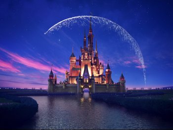 A large castle with a fountain in the middle of it