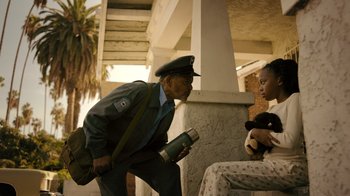 Movie still from “Snowfall” (2017), directed by Hiro Murai – An old man in a military uniform talking to a young girl; Medium shot, Low angle