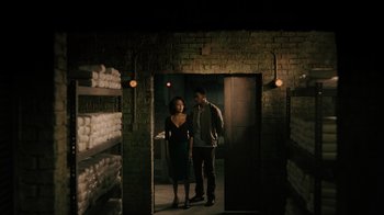 Movie still from “Snowfall” (2017), directed by Hiro Murai – A man and a woman are standing in a room; Wide shot, Low angle