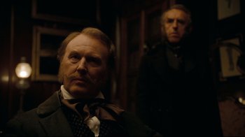 Movie still from “Alice in Wonderland” (2010), directed by Tim Burton – A man with a beard and mustache and a man with a beard and mustache; Close Up shot, Over the shoulder angle