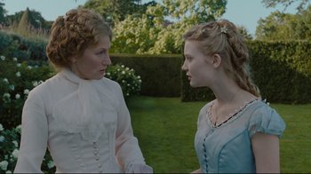Movie still from “Alice in Wonderland” (2010), directed by Tim Burton – Two women are talking in a garden setting; Close Up shot, Over the shoulder angle