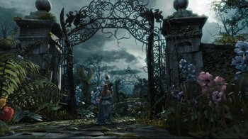 Movie still from “Alice in Wonderland” (2010), directed by Tim Burton – An artistic painting of a woman standing under an iron gate; Wide shot, High angle