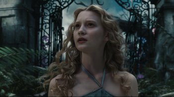 Movie still from “Alice in Wonderland” (2010), directed by Tim Burton – A woman with long blonde curly hair wearing a blue dress; Close Up shot, Low angle