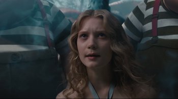 Movie still from “Alice in Wonderland” (2010), directed by Tim Burton – A woman with long blonde curly hair looking at the camera; Close Up shot, Low angle