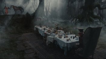 Movie still from “Alice in Wonderland” (2010), directed by Tim Burton – A table set up for an outdoor dinner party; Wide shot, High angle