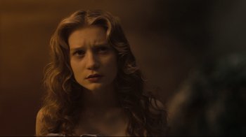 Movie still from “Alice in Wonderland” (2010), directed by Tim Burton – A woman with long curly hair stares into the camera; Close Up shot, Low angle
