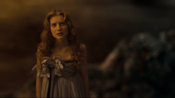 Movie still from “Alice in Wonderland” (2010), directed by Tim Burton – A woman with long hair wearing a white dress; Close Up shot, Low angle
