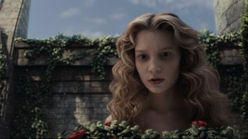 Movie still from “Alice in Wonderland” (2010), directed by Tim Burton – A woman with long blonde curly hair wearing a dress; Close Up shot, High angle