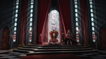 Movie still from “Alice in Wonderland” (2010), directed by Tim Burton – Two women sitting on steps in front of a stained glass window; Wide shot, High angle
